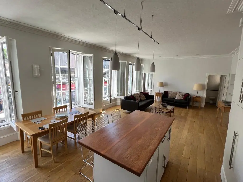 a kitchen and living room with a table and chairs at Central 1-Bed Apartment in Inverness Sleeps 4 in Inverness