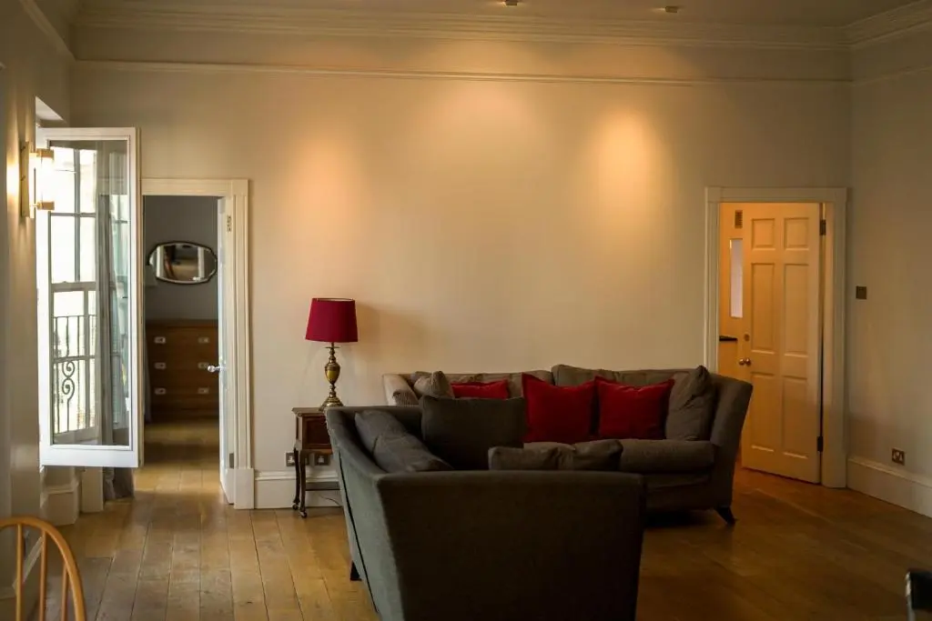 a living room with a gray couch and red pillows at Central 1-Bed Apartment in Inverness Sleeps 4 in Inverness