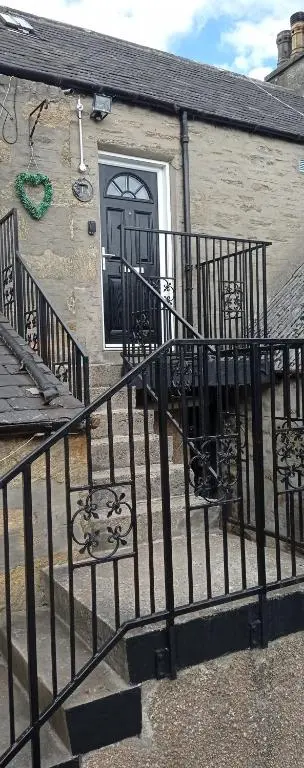 a building with a black gate and a door at Isla Way Stays in Keith