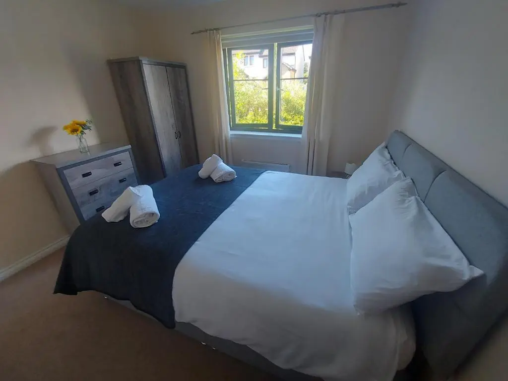a bedroom with a large bed with two pillows on it at The Mews in Inverness