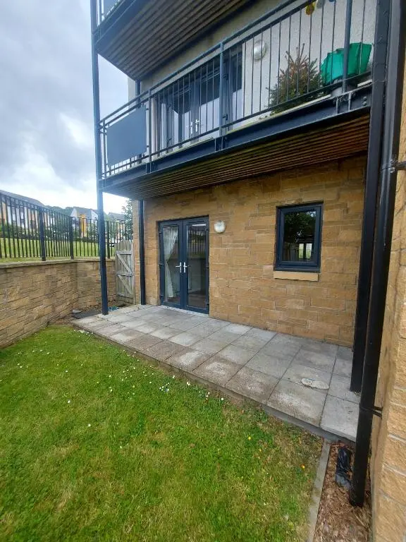 a brick building with a patio and a balcony at The Mews in Inverness