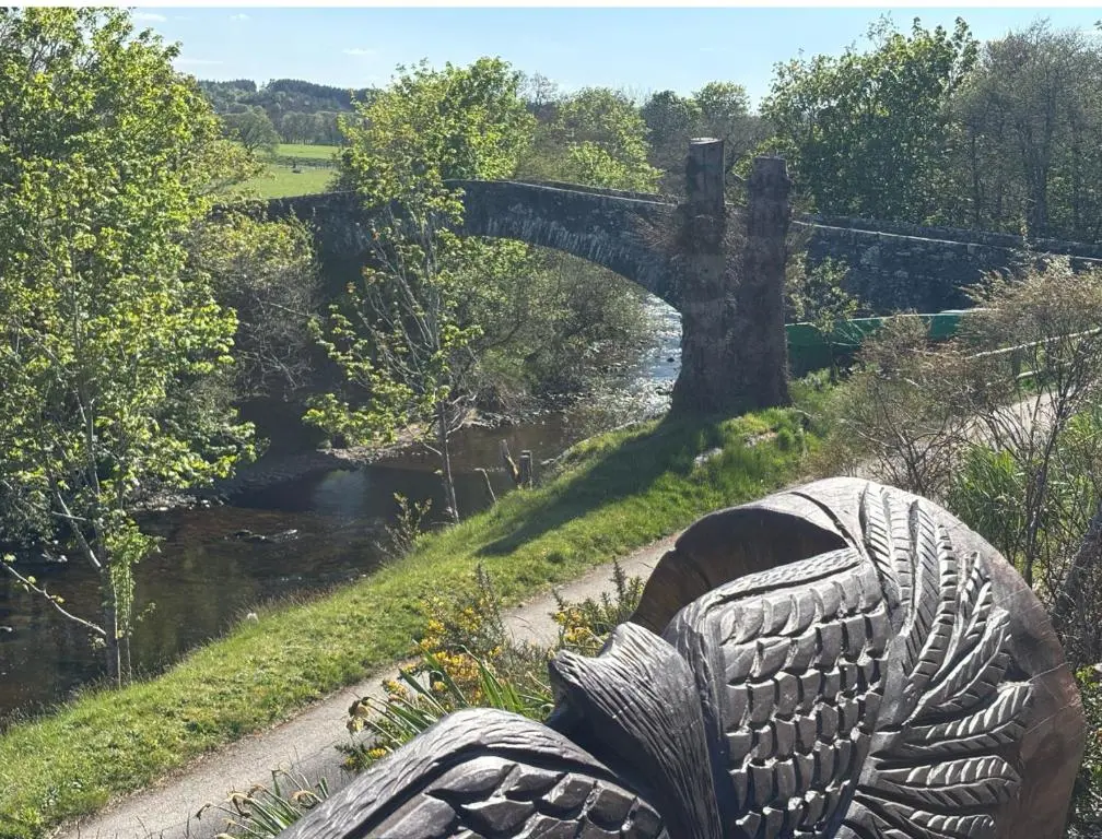 a statue of a person looking at a river at The Guest suite at Daviot ,Inverness in Inverness