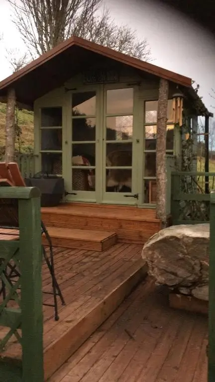a screened in porch on a wooden deck at The Guest suite at Daviot ,Inverness in Inverness