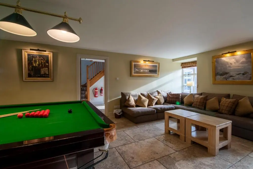 a living room with a pool table and a couch at Quarryfield in Inverness