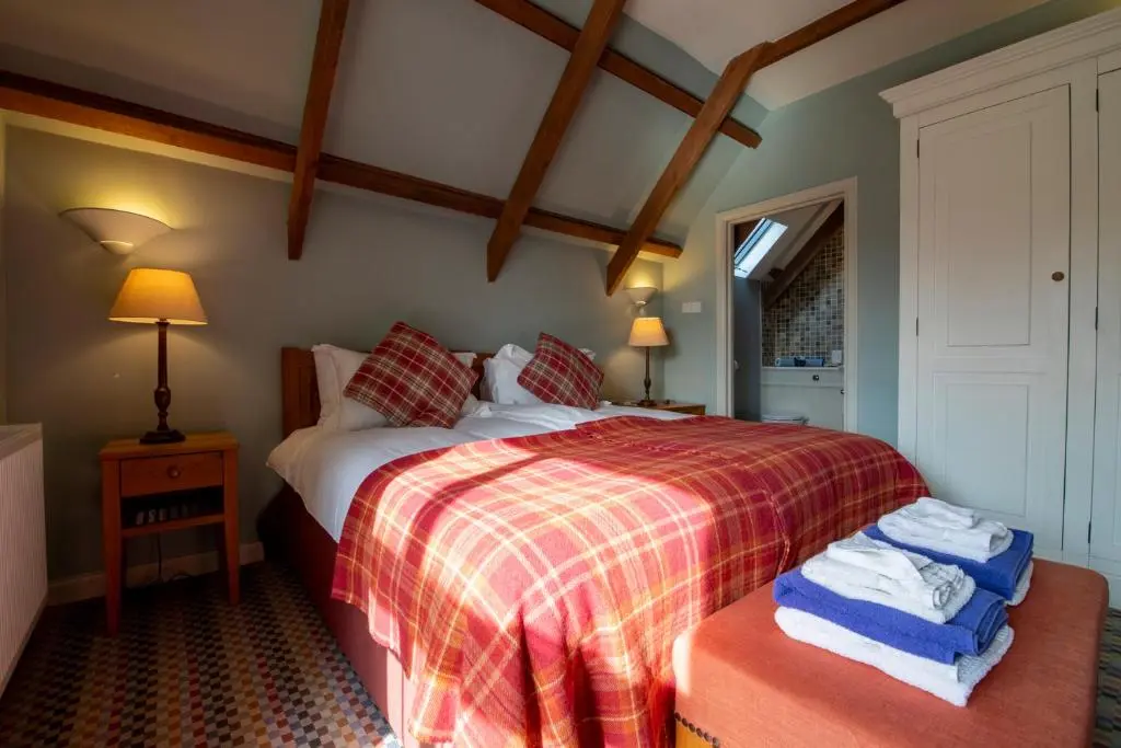 a bedroom with a bed with towels on it at Quarryfield in Inverness