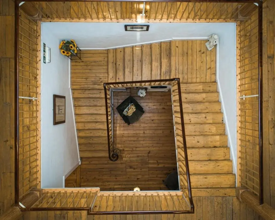 a wooden stairs in a room with a shower at Cortes House in Fraserburgh