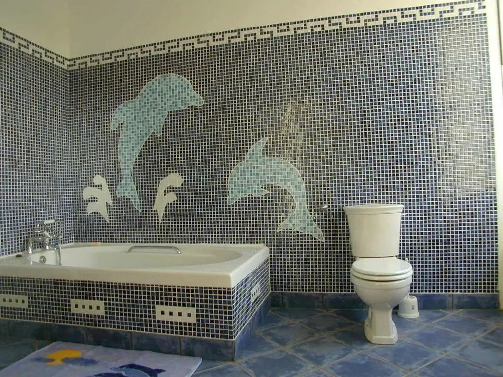 a bathroom with a bath tub and a toilet at Cortes House in Fraserburgh
