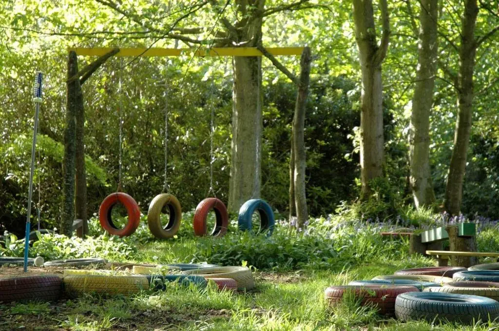 a garden with a bunch of tires in the grass at Cortes House in Fraserburgh