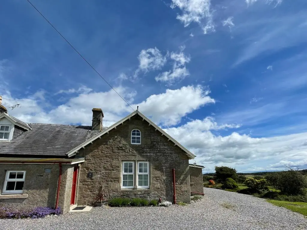 a stone house sitting on a gravel road at Birch Cottage - Uk38992 in Dalcross
