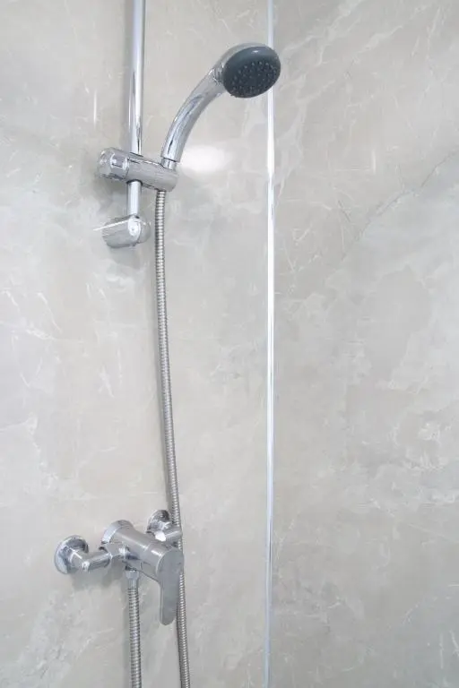 a shower with a shower head in a bathroom at Aria Lodging Inverness in Inverness