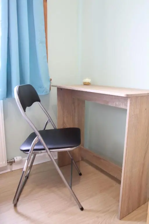 a black chair sitting next to a desk at Aria Lodging Inverness in Inverness