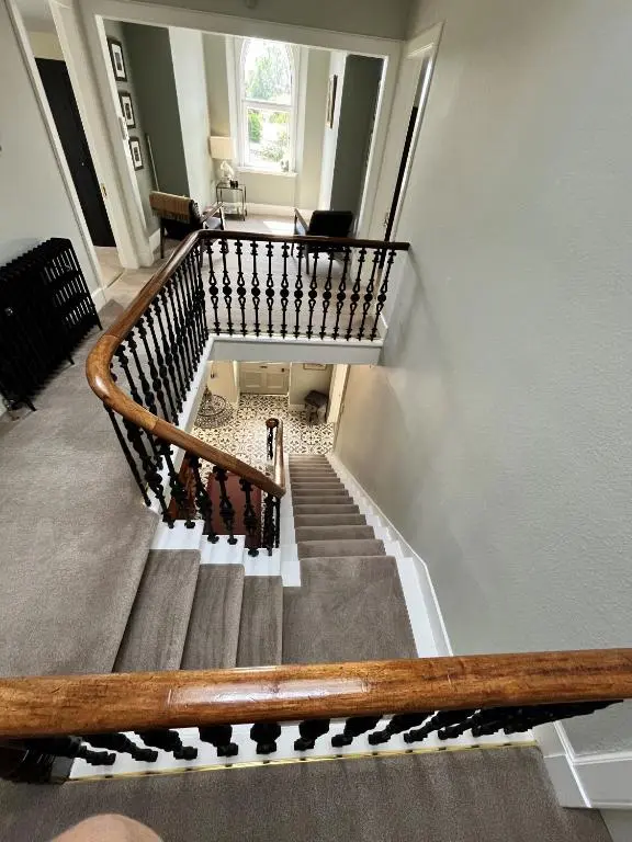 a spiral staircase in a building with a stair case at Beinn Mhor Lodge, 63 Culduthel Road in Inverness