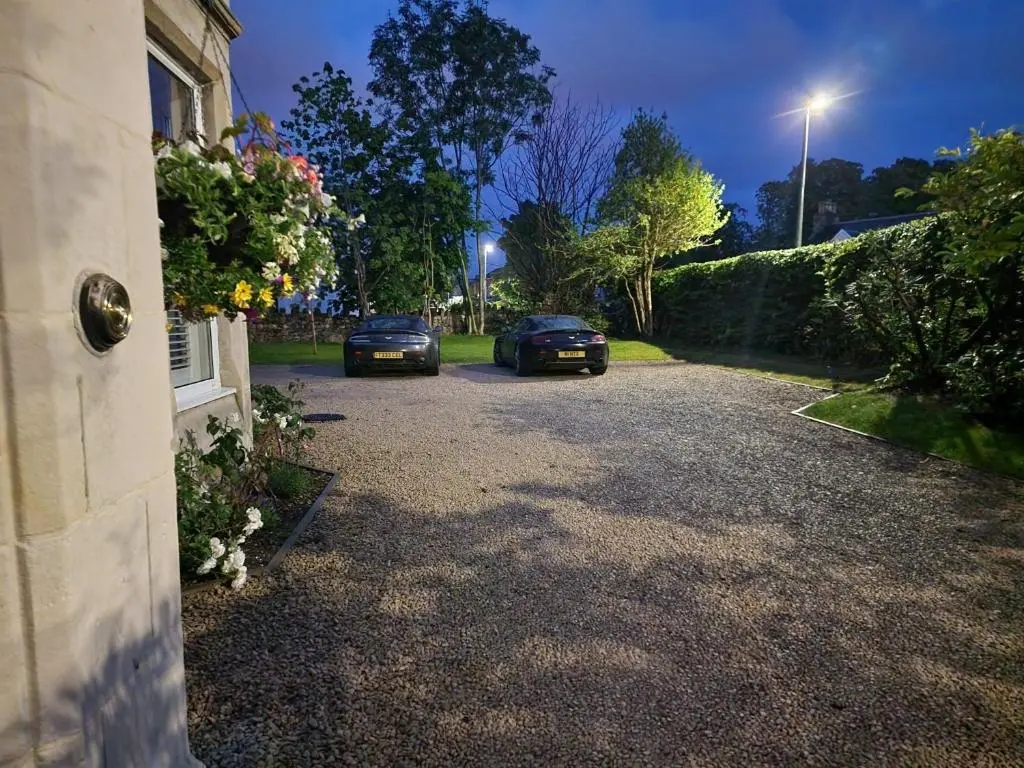 two cars parked in the driveway of a house at Beinn Mhor Lodge, 63 Culduthel Road in Inverness