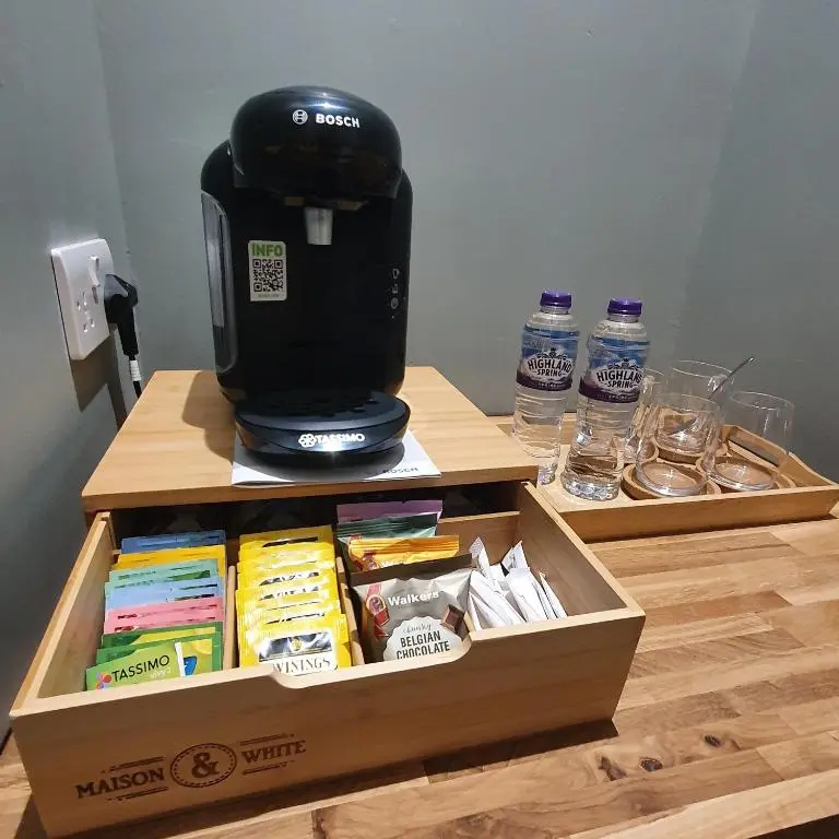 a coffee maker sitting on top of a box on a table at Beinn Mhor Lodge, 63 Culduthel Road in Inverness