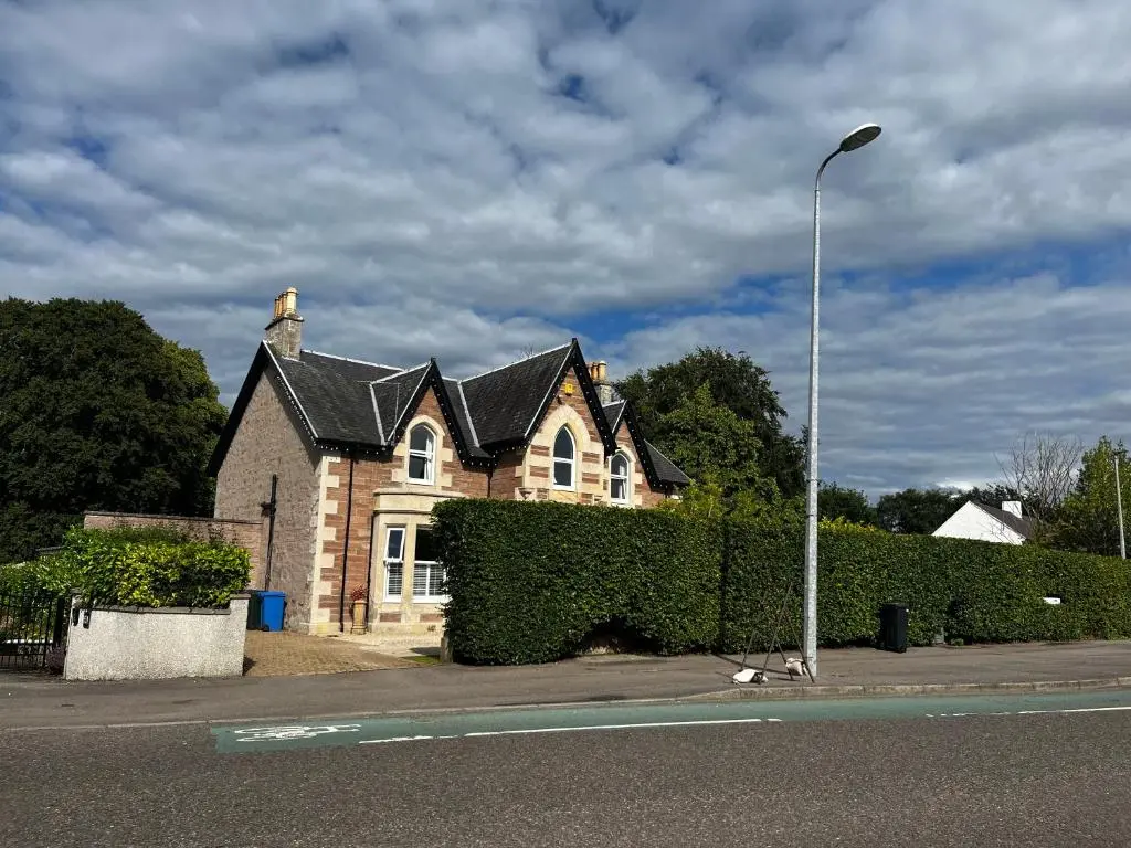 a house on the side of a street with a street light at Beinn Mhor Lodge, 63 Culduthel Road in Inverness