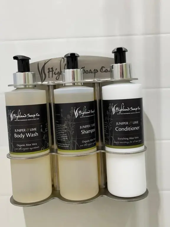 a group of four bottles of soap on a shelf at The Cabin, Stronua. A beautiful 1 bedroom cabin. in Fort Augustus