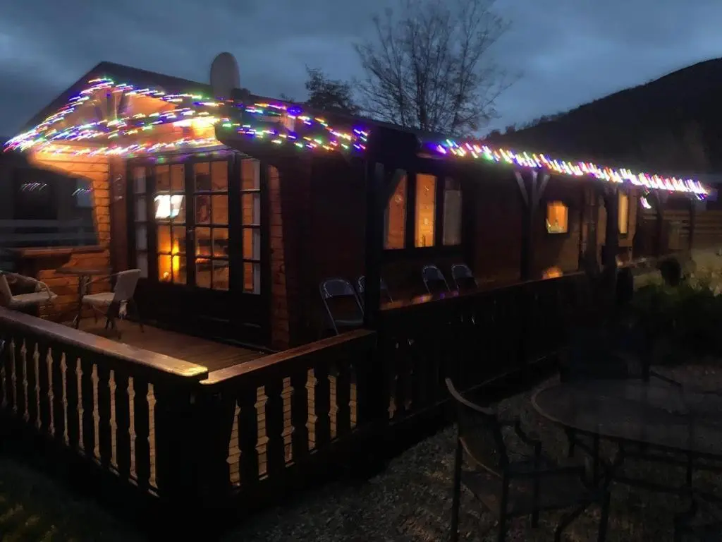 a tiny house with christmas lights on the roof at RIVERSIDE LODGE RETREAT in Aviemore