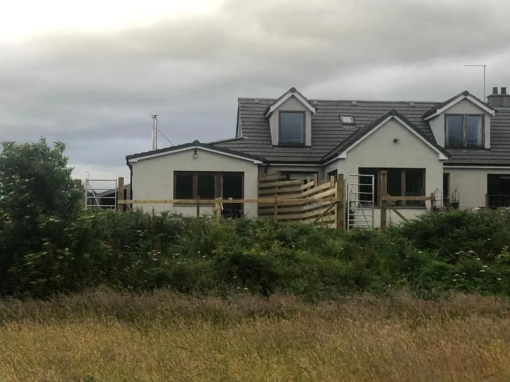 a white house with a gambrel roof at River Ness View in Inverness