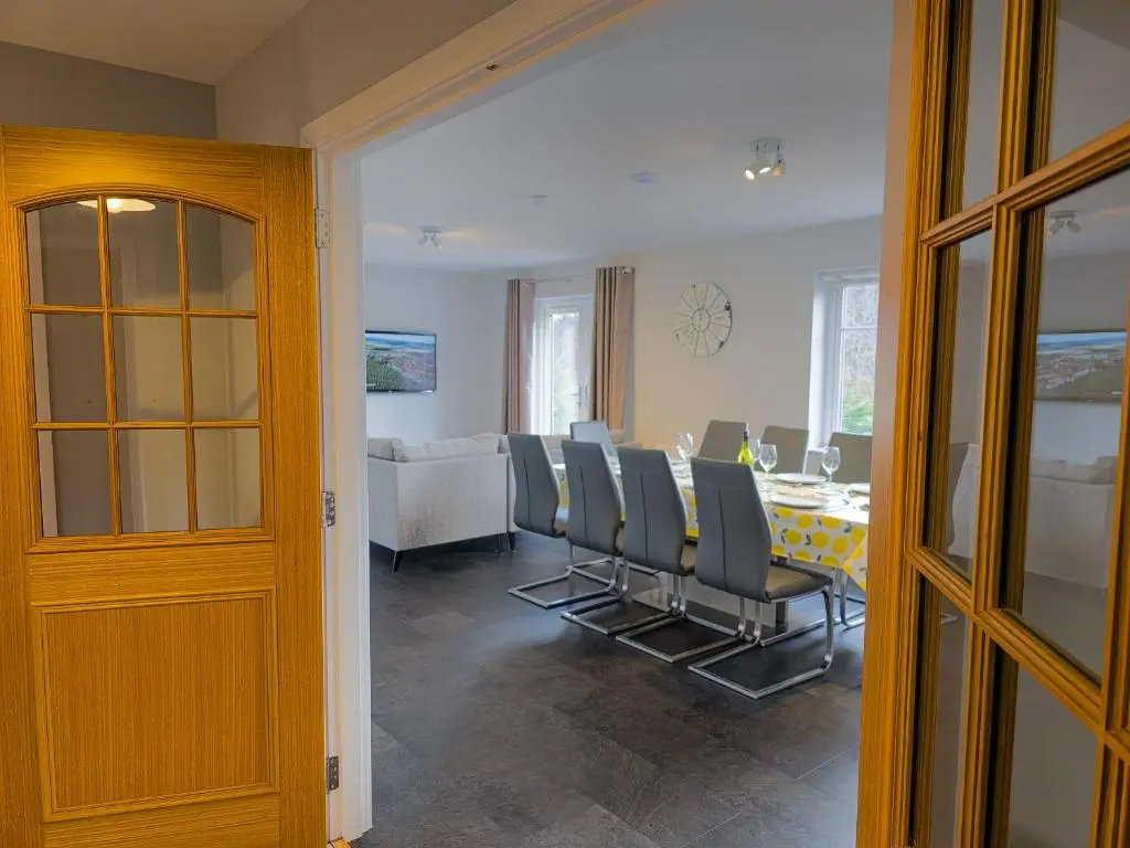 a dining room with a table and chairs at Braeside - Family home in Nethy Bridge in Nethy Bridge