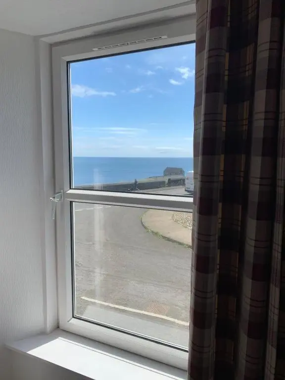 a window with a view of the ocean at Caithness Stone house in Wick