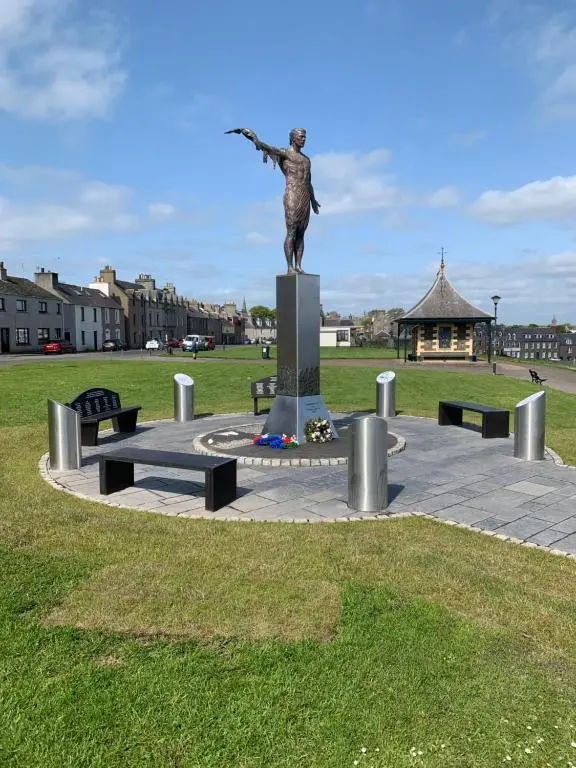 a statue of a woman with her arm out at Caithness Stone house in Wick