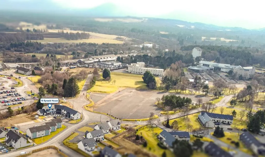 an aerial view of a town with a parking lot at 10 Bynack House in Aviemore