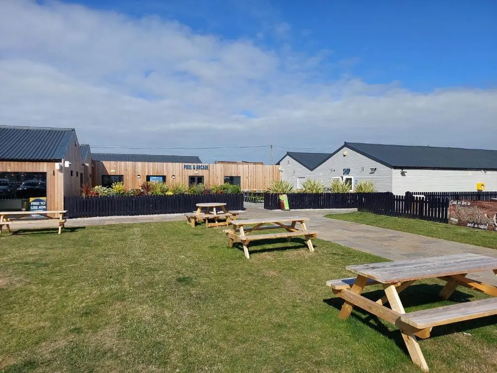 a group of picnic tables in the grass at Aurora Way 81 in Lossiemouth