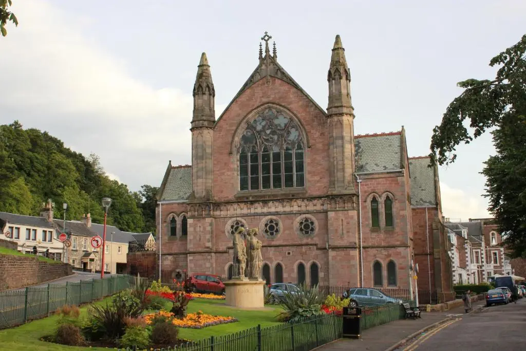a church with a statue in front of it at Ness View Apartment in Inverness
