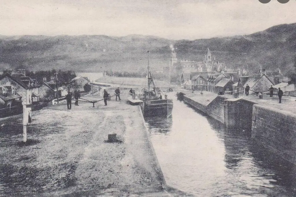 a black and white photo of a river with a town at 3 BR Luxury Apt at Highland Club - Fort Augustus in Fort Augustus