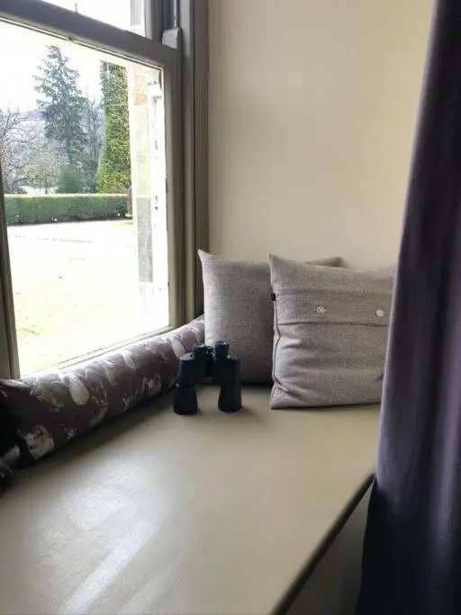 a room with a window and pillows on a table at 3 BR Luxury Apt at Highland Club - Fort Augustus in Fort Augustus