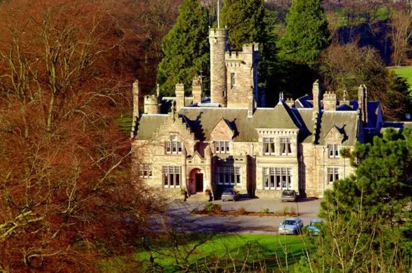 a large castle with a car parked in front of it at Mansion House Hotel in Elgin