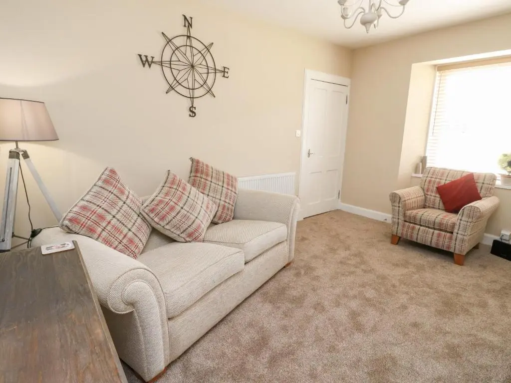 a living room with a couch and a table at Ulla Dhu in Nethy Bridge