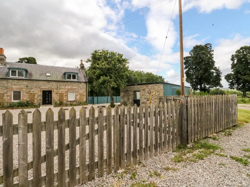 a wooden fence in front of a house at Ulla Dhu in Nethy Bridge