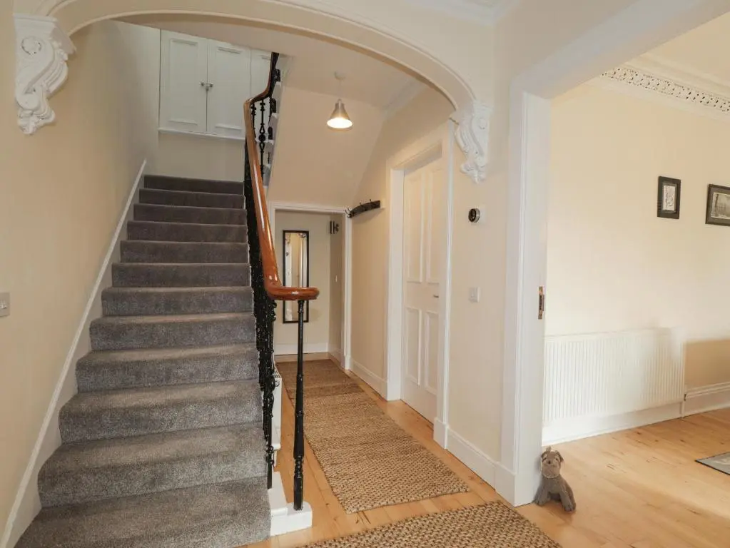 a staircase in a home with an archway at Ballinreich in Inverness