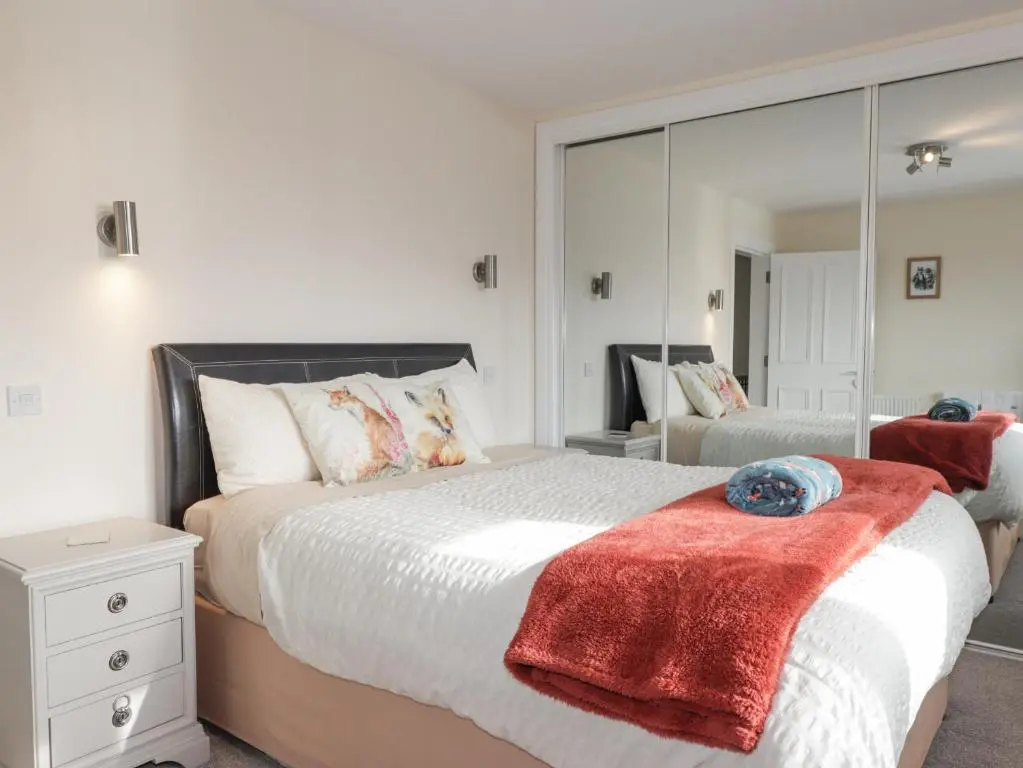a bedroom with a large bed and a mirror at Ballinreich in Inverness
