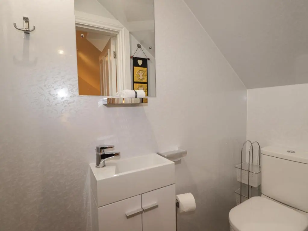 a white bathroom with a sink and a toilet at Ballinreich in Inverness