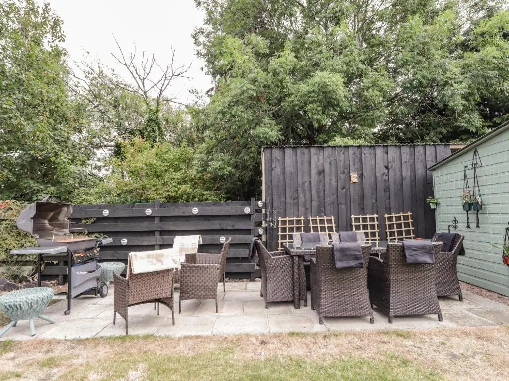 a patio with chairs and a table and a grill at Ballinreich in Inverness