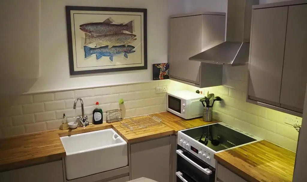 a small kitchen with a sink and a microwave at The Fiddichside Inn in Aberlour