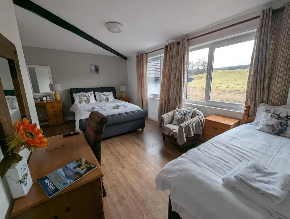 a hotel room with two beds and a window at Old North Inn Hotel in Kirkhill