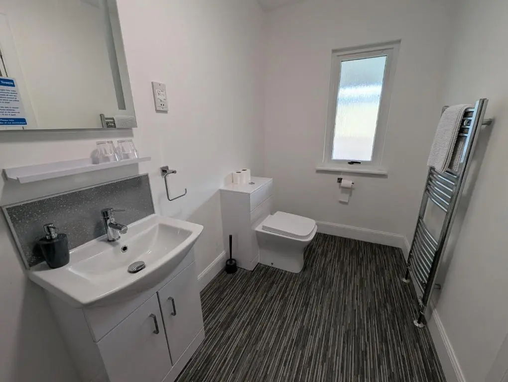 a white bathroom with a sink and a toilet at Old North Inn Hotel in Kirkhill