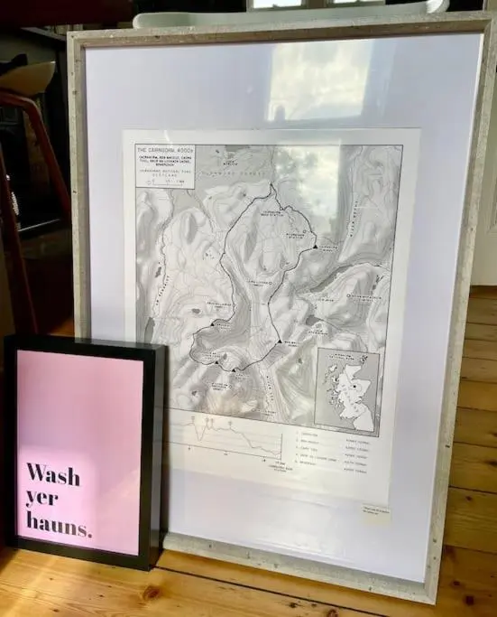 a picture of a map in a frame on a table at *Cool, cosy cottage in the heart of the Highlands* in Kincraig