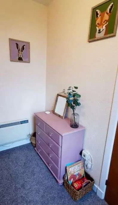 a room with a dresser with a picture on the wall at *Cool, cosy cottage in the heart of the Highlands* in Kincraig
