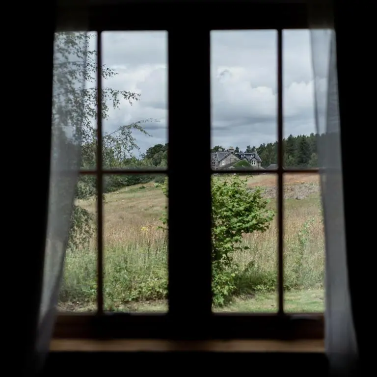 a view of a field from a window at Balnagowan Cottage in Nethy Bridge