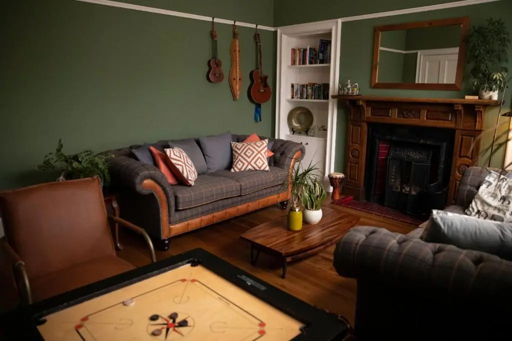 a living room with a couch and a pool table at The old church house in Inverness