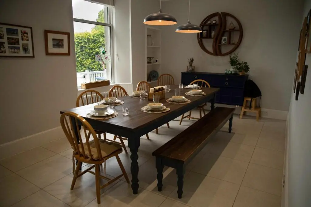 a dining room with a wooden table and chairs at The old church house in Inverness
