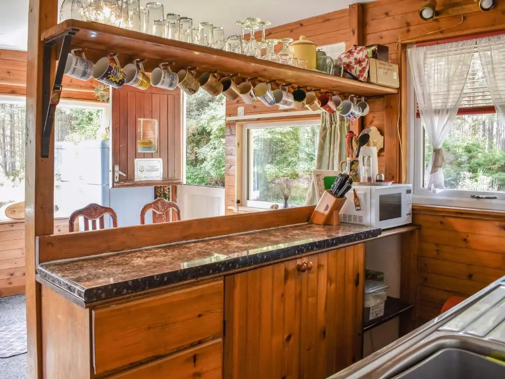 a kitchen with wooden cabinets and a counter top at The Chalet - Ukc5786 in Nethy Bridge