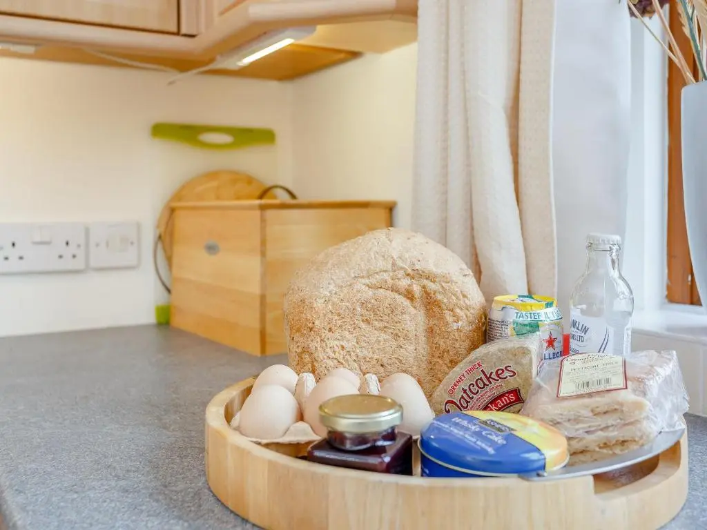 a bowl filled with eggs and bread on a kitchen counter at Caldon Cottage in Cromarty
