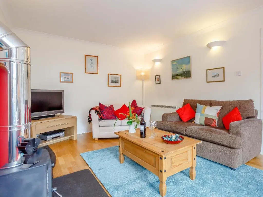 a living room with a couch and a coffee table at Caldon Cottage in Cromarty