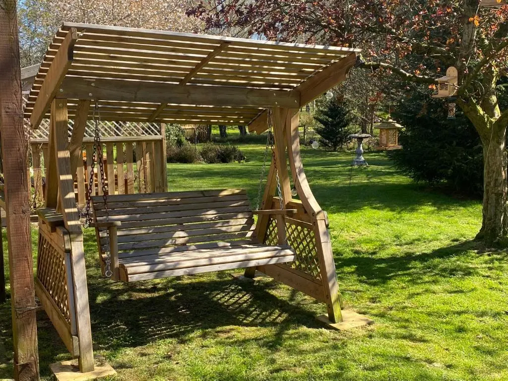 a wooden gazebo with a teddy bear sitting on it at Drummond Neuk - Pets Welcome free, country setting, free onsite parking in Inverness