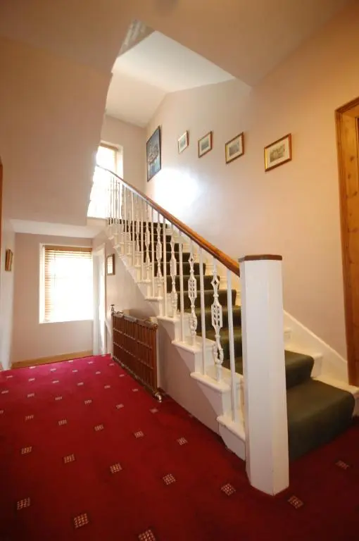 a staircase in a house with a red carpet at The Old Manse, Fochabers in Fochabers